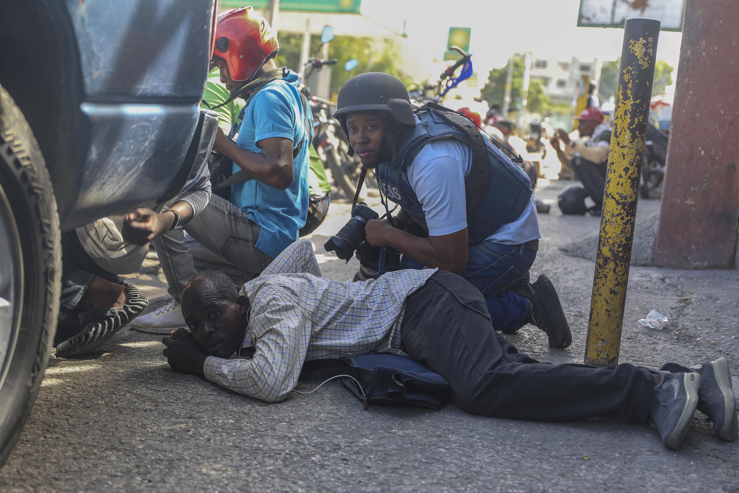 Haiti swears in a new prime minister as gangs open fire at a flight landing in the main airport